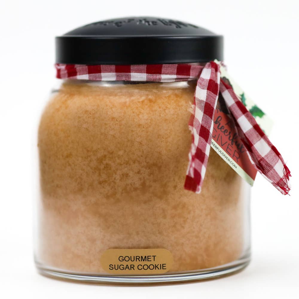 Jar of gourmet sugar cookie mix with a red and white checkered ribbon on a white background