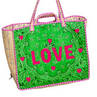 A woven tote bag with a bright green front panel featuring a paisley bandana pattern, pink embroidered hearts, and the word 'LOVE' in large pink letters. The sides of the bag are natural beige woven material, and it has pink and green striped handles.