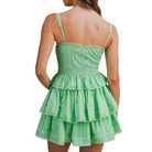 Green tiered set worn by a person on a white background