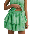 Green tiered skirt set with floral pattern on a white background