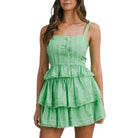 Green tiered set worn by a model on a white background