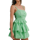 Green tiered set worn by a model on a white background