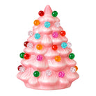 A pink Christmas tree figurine decorated with colorful faceted ornaments in red, green, orange, turquoise, and pink, set against a plain white background.