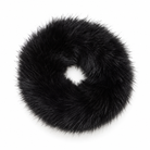 A black faux fur donut hair scrunchie, photographed from directly above on a clean white background.