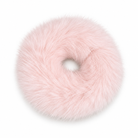A fluffy, circular donut-shaped accessory in a soft light pink faux fur material, shown against a plain white background.