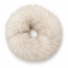 A fluffy faux-fur donut-shaped hair accessory in a warm cream or ivory tone, photographed on a clean white background.
