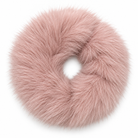 A dusty pink faux fur hair scrunchie, shown from a top-down view on a solid white background.