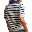 Person wearing a white and blue striped sweater on a white background