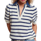 Woman wearing a blue and white striped shirt with a collar on a white background