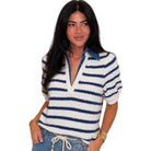 Woman wearing a blue and white striped sweater on a white background