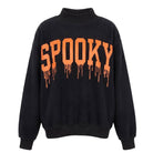 A black mock neck sweatshirt featuring the word 'SPOOKY' printed across the chest in a dripping orange font, shown against a plain white background.