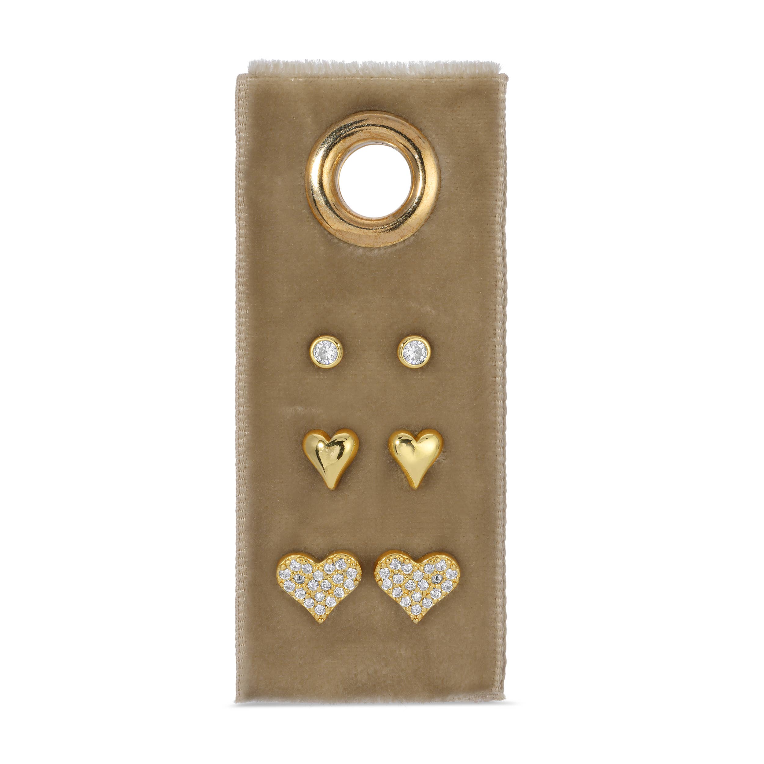 Set of gold and heart-shaped earrings on a beige card with a gold ring.