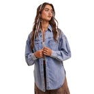 Woman wearing a light blue denim shirt on a white background