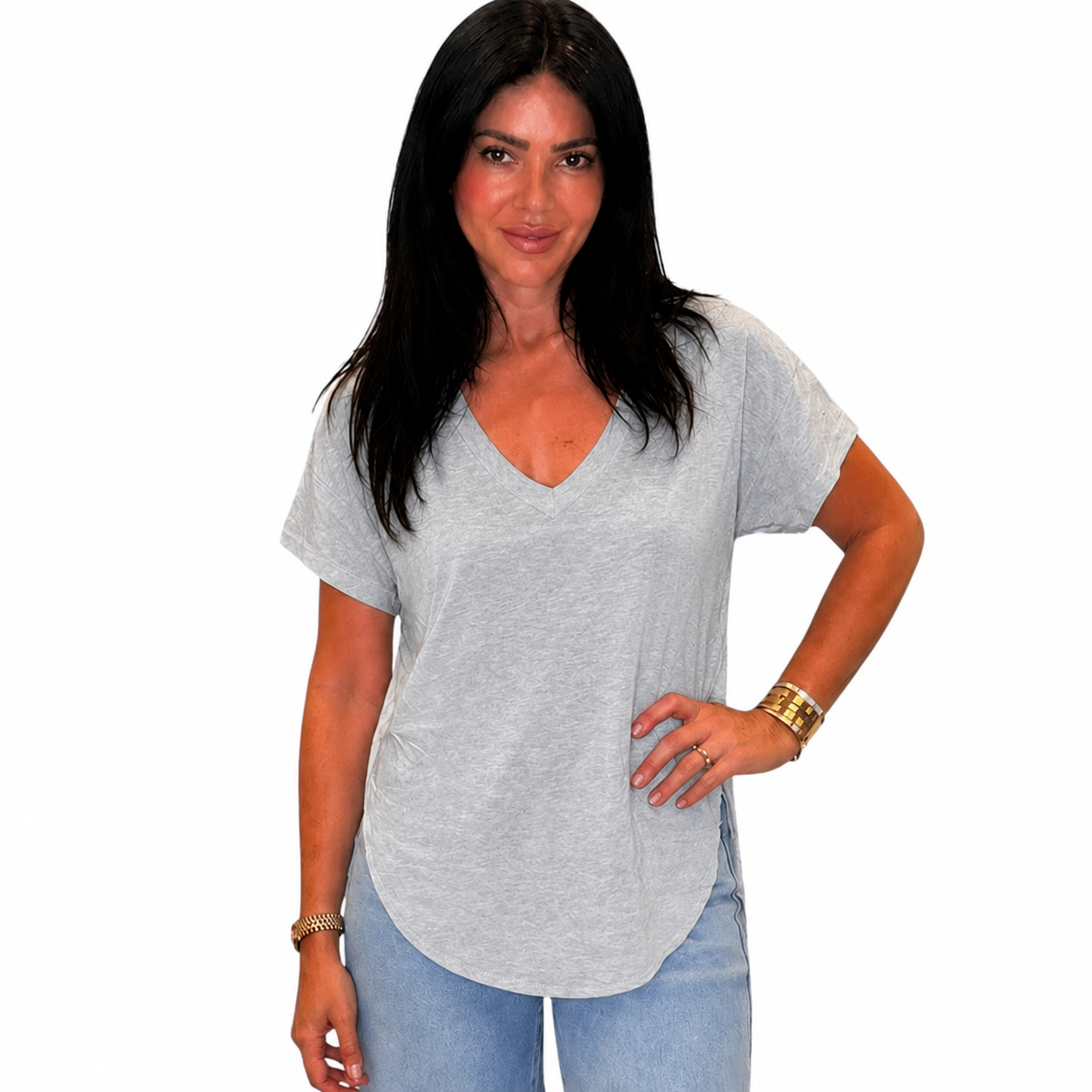 Woman wearing a gray t-shirt and blue jeans on a white background