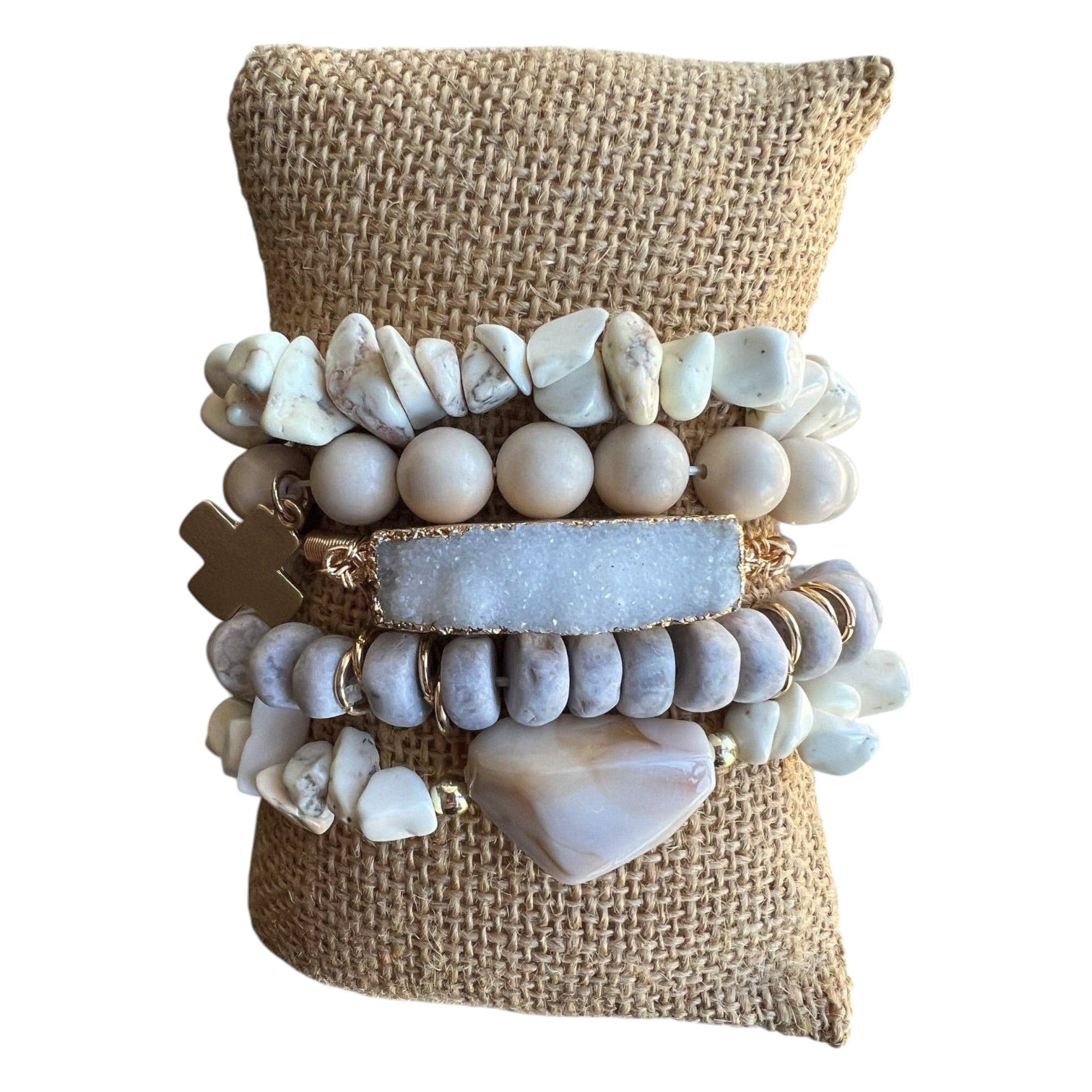 Collection of bracelets on a burlap bag with a white background