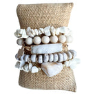 Stack of stone and bead bracelets on a burlap surface
