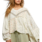 Woman wearing a white lace blouse with long sleeves on a white background