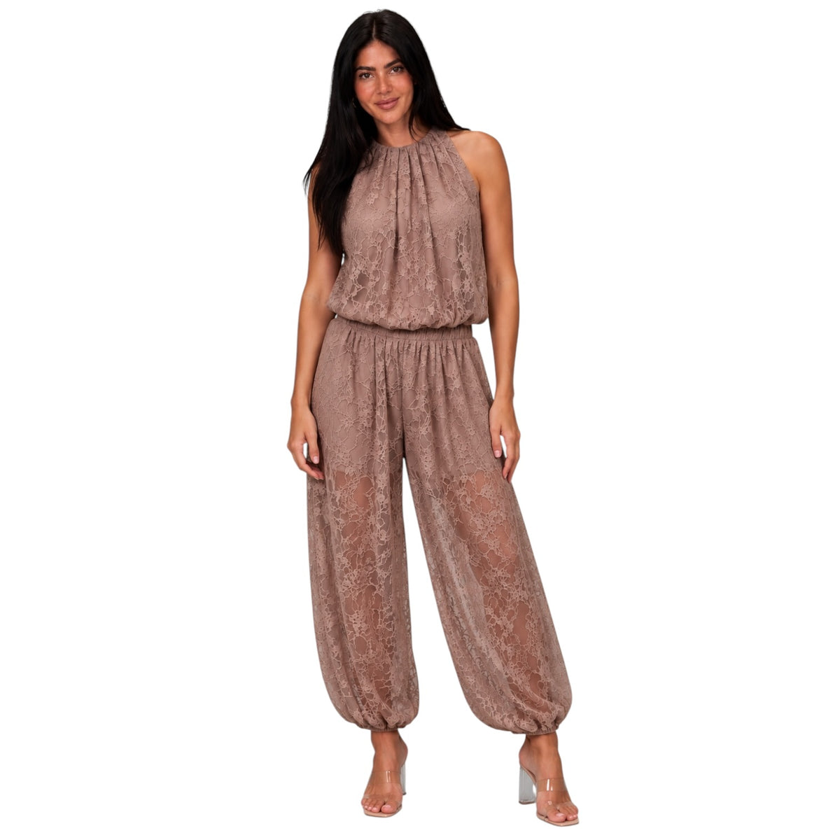 A woman modeling a sleeveless, high-neck harem-style jumpsuit in a dusty rose-brown lace fabric, set against a plain white background.