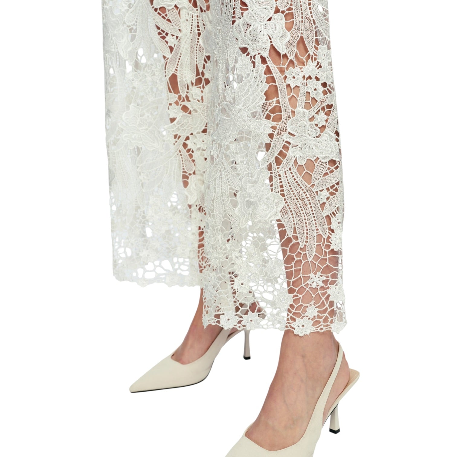 White lace dress with beige high-heeled shoes on a white background
