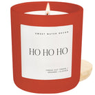 Red candle with 'HO HO HO' label on a white background