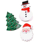 Three Christmas-themed paper cutouts or stickers on a plain white background: a green Christmas tree with red and blue dots, a white snowman with a red scarf and black hat, and a white Santa face with a red hat.