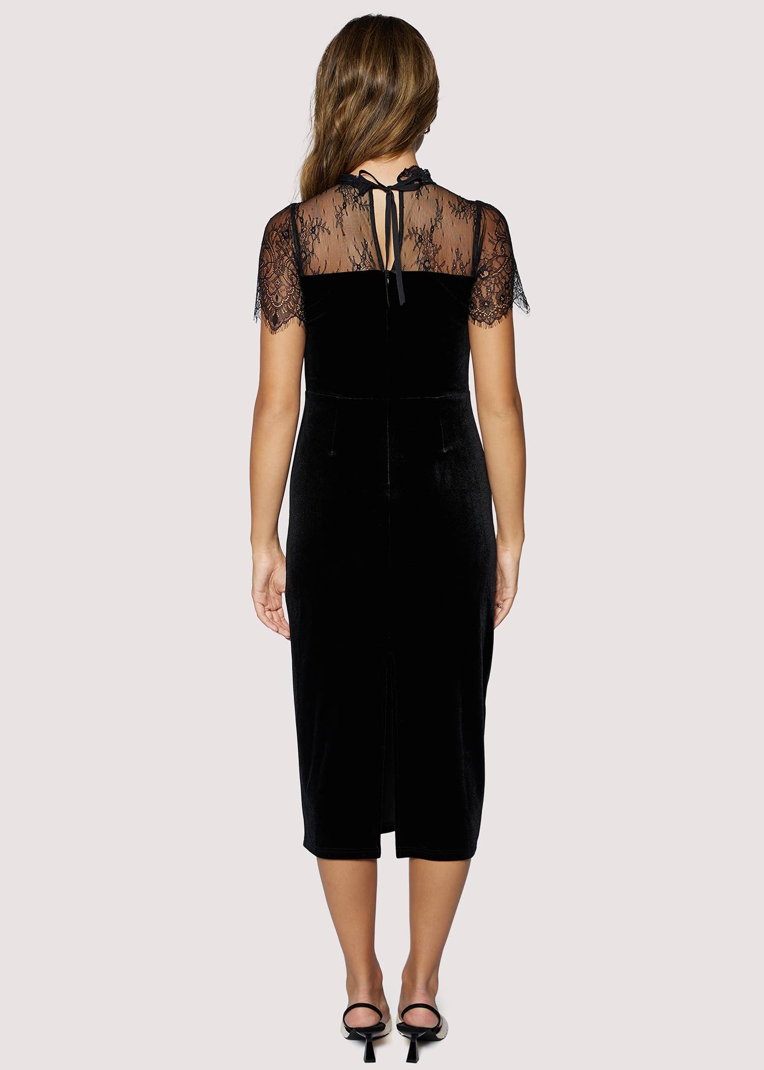 Black dress with lace details on a white background