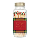 A clear glass jar filled with safety matches, sealed with a gold metal lid and wrapped in a red label that reads 'SAFETY matches No. 60' with green plaid trim.