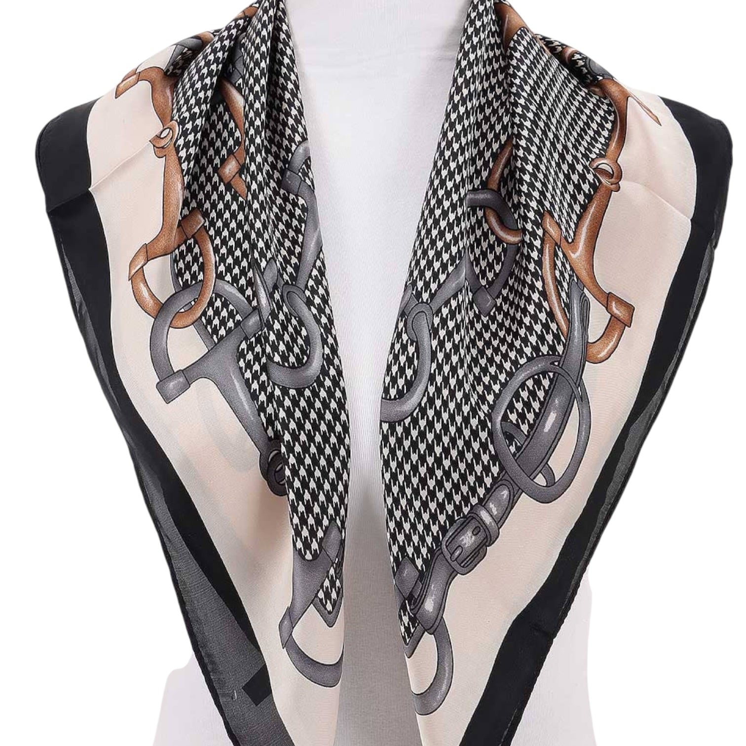 Black and white patterned sandals with decorative straps on a mannequin.