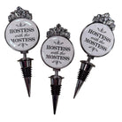 Three bottle stoppers with 'Hostess with the Mostest' text on a white background