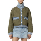 A model wearing a quilted olive green jacket with light blue denim trim, featuring a high stand-up collar, button-front placket, and two flap pockets on a white background.