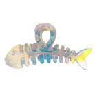 Iridescent fish-shaped hair comb on a white background