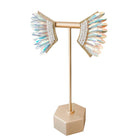 Earring stand with beaded earrings on a white background
