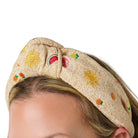 natural knotted headband with graphics of sun and fruit on a white background