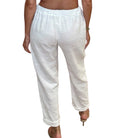 White pants worn by a person on a white background