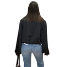 model wearing black satin balloon sleeve blouse