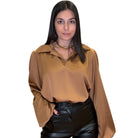 model wearing camel satin blouse