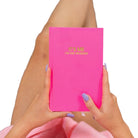 Person holding a pink notebook with 'It's Me, I'm the Problem' text on a white background
