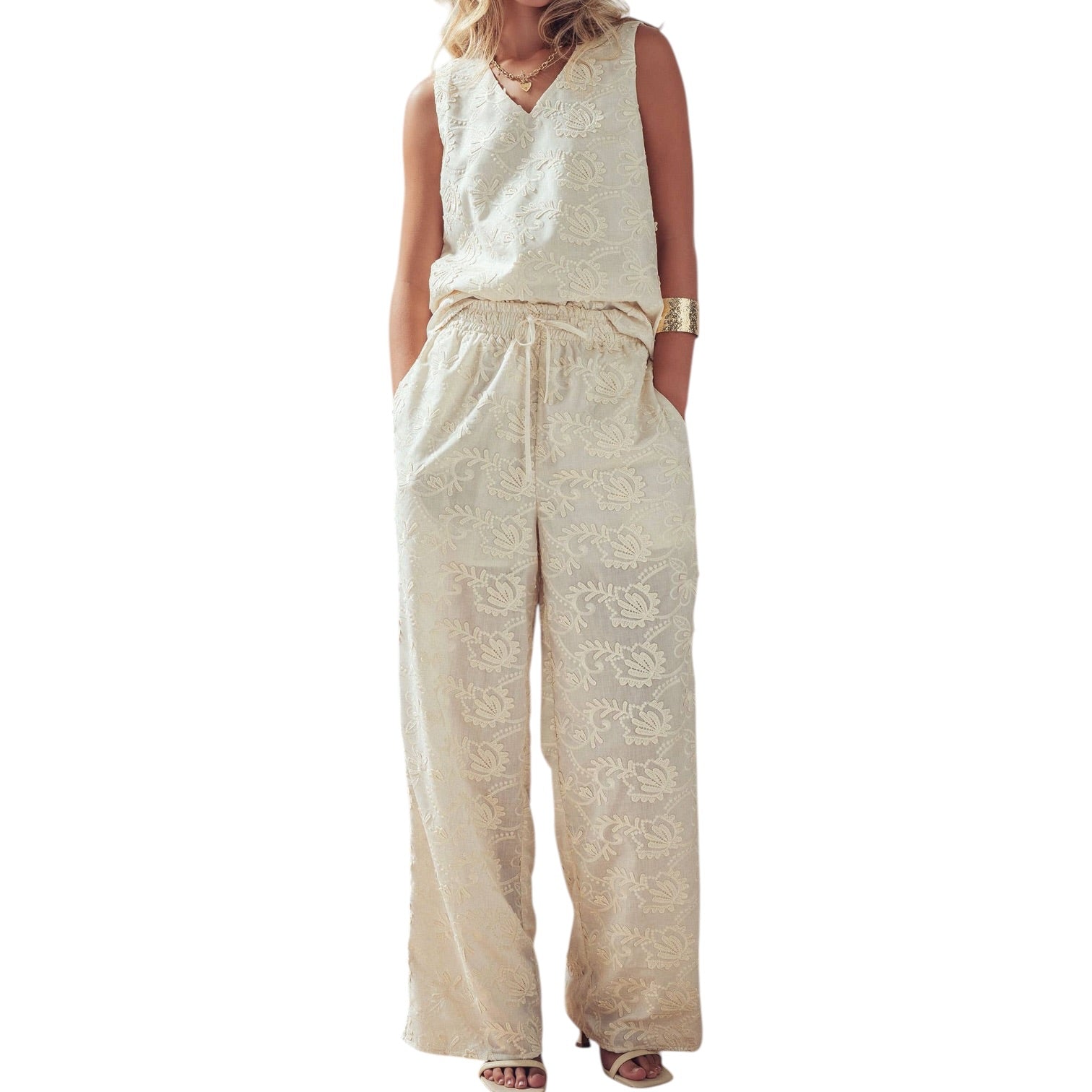 Beige lace jumpsuit worn by a model on a white background