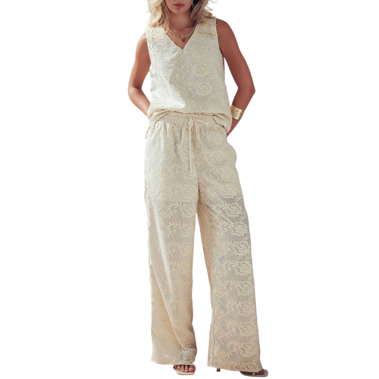 Woman wearing a beige lace jumpsuit on a white background