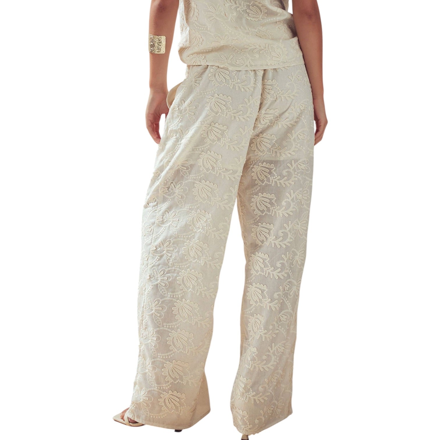Beige embroidered pants on a white background