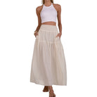 Woman wearing a white top and beige checkered skirt on a white background
