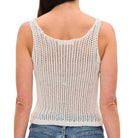 Person wearing a white knit tank top on a white background