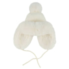 An off-white knit winter hat with a matching faux fur ear warmer and pom-pom, featuring adjustable chin ties, shown against a plain white background.