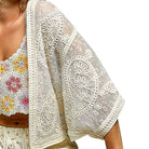 White lace cover-up with floral top on a white background
