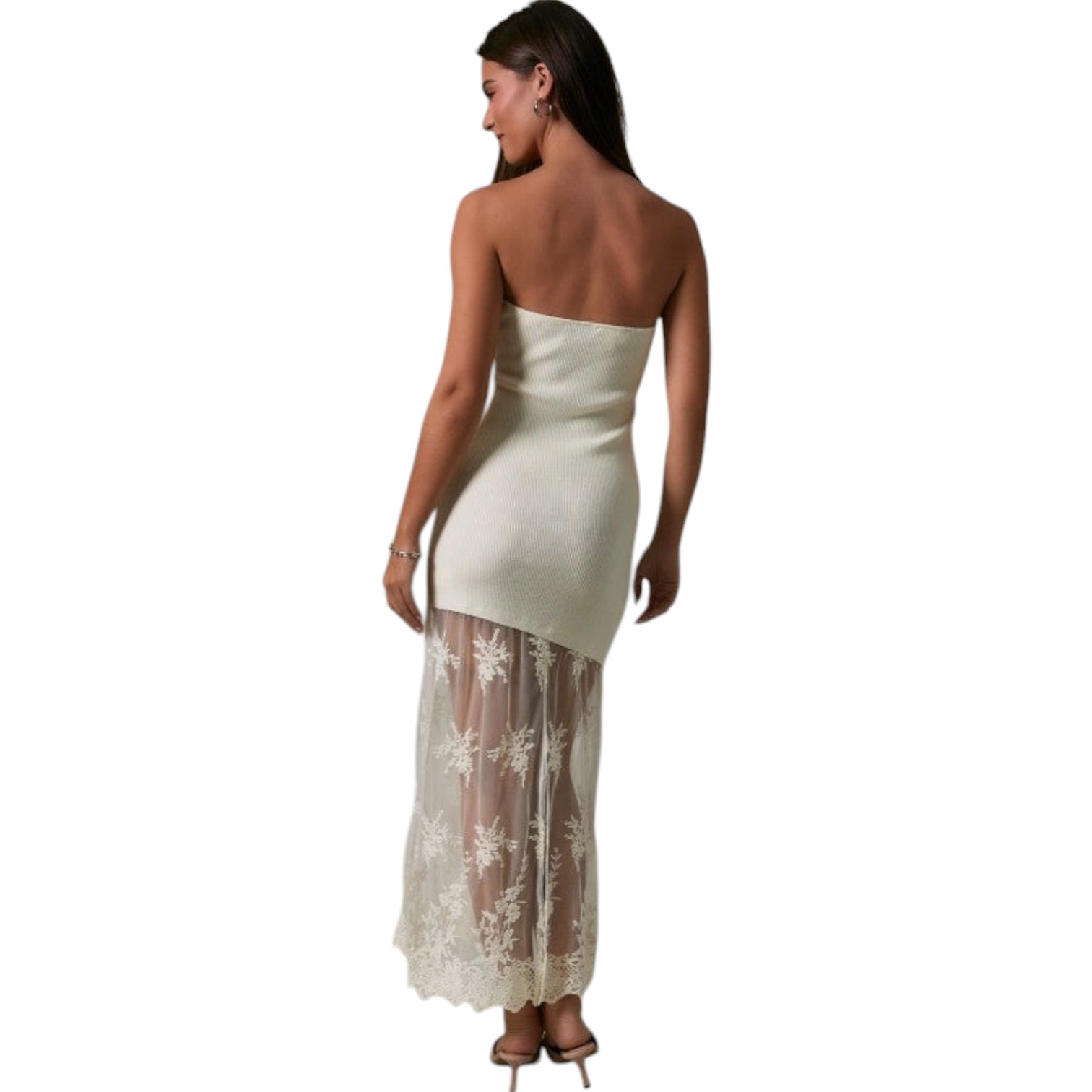 Woman wearing a strapless white dress with a sheer lace overlay on a white background