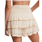 Beige layered skort worn by a person on a white background