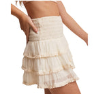 Beige tiered skort worn by a person on a white background