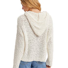 White textured hoodie worn by a person on a white background