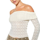 White off-shoulder top with lace detailing on a white background