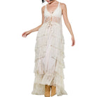 Cream lace dress with tiered layers on a white background